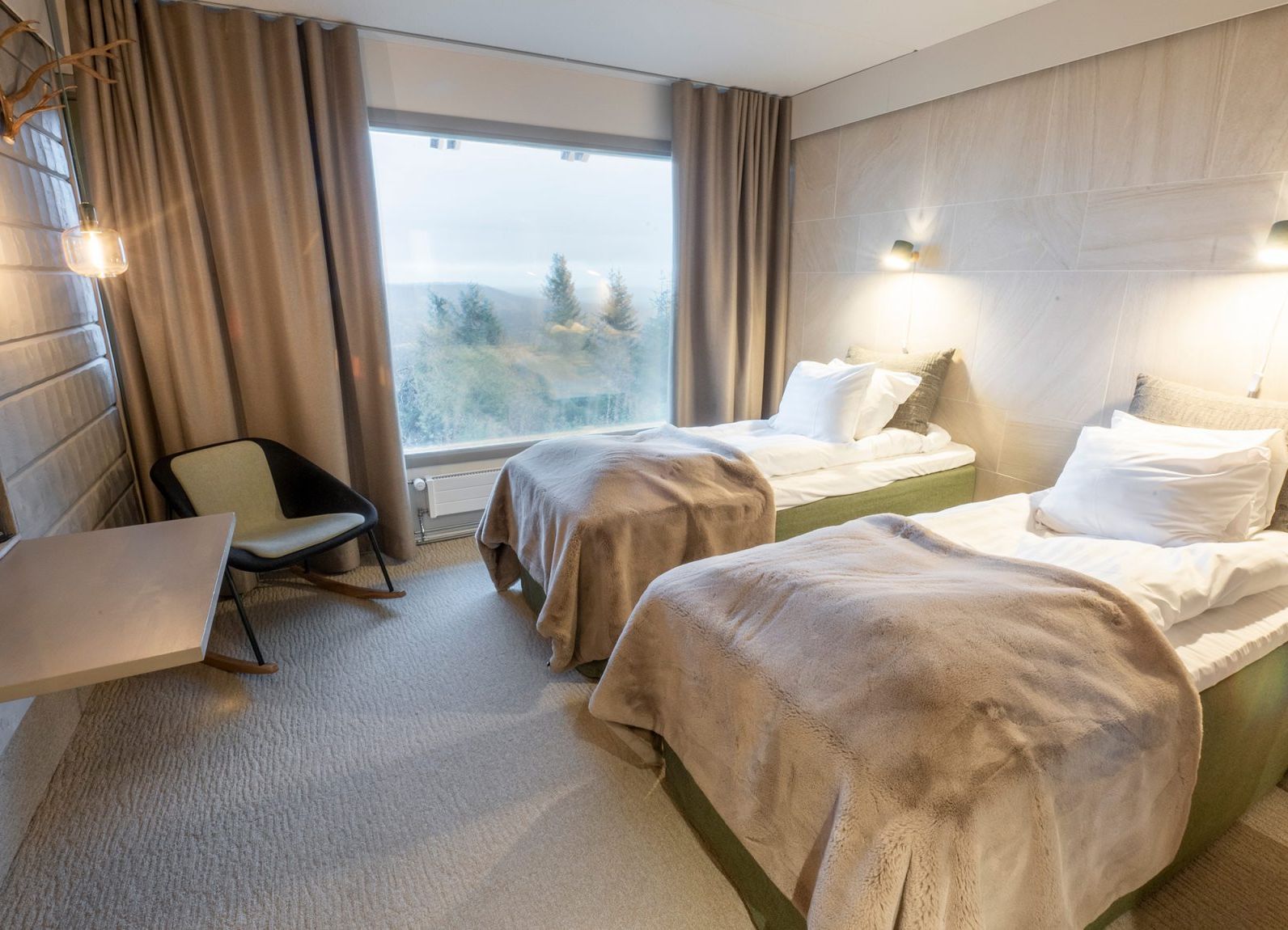 Comfortable hotel room at Hilltop Hotel Iso-Syöte with views of the surrounding nature